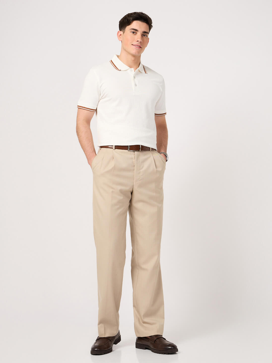 man wearing a classic white polo t-shirt with jacquard collar and beige trouser