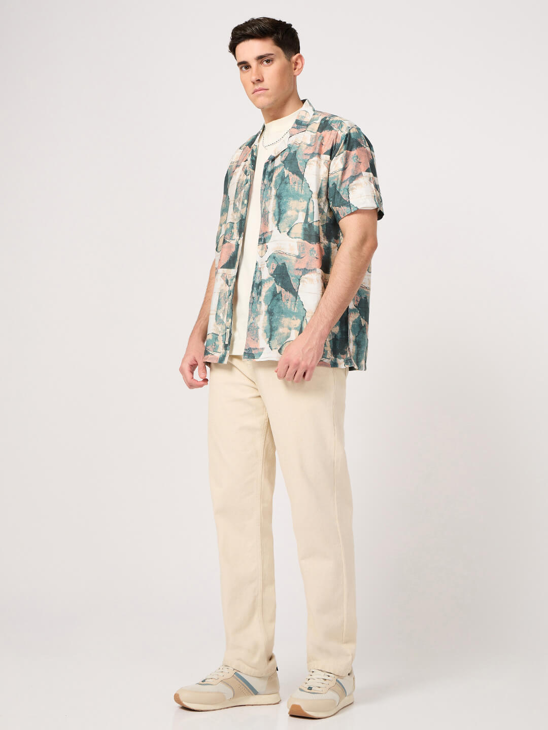 A man wearing a stylish rayon resort shirt with beige trouser