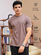 Man wearing a brown crew neck t-shirt with bio-wash technology, softness, breathable fabric