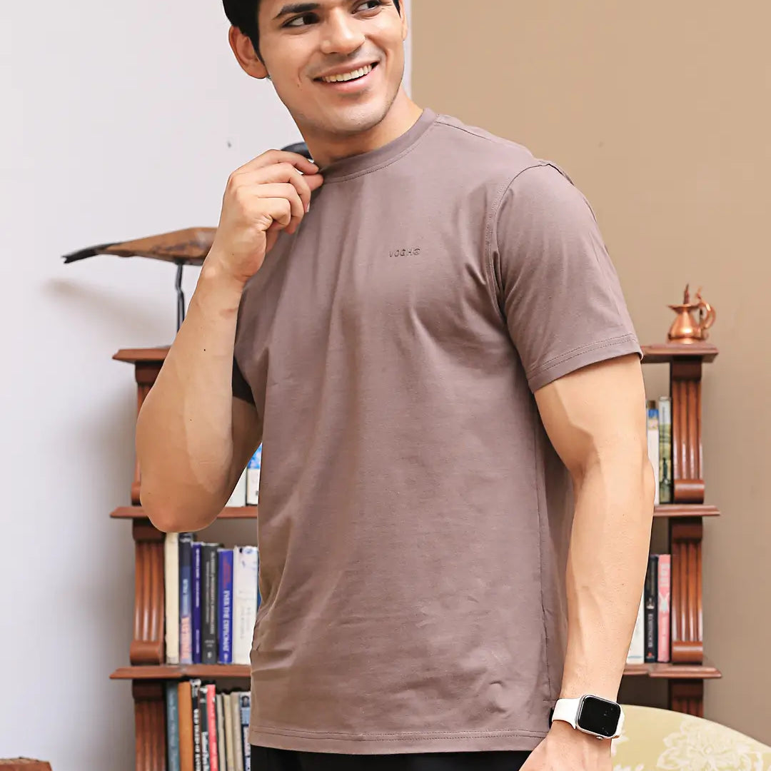Man wearing a brown crew neck t-shirt made with bio-wash cotton fabric