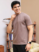 Man wearing a brown crew neck t-shirt made with bio-wash cotton fabric