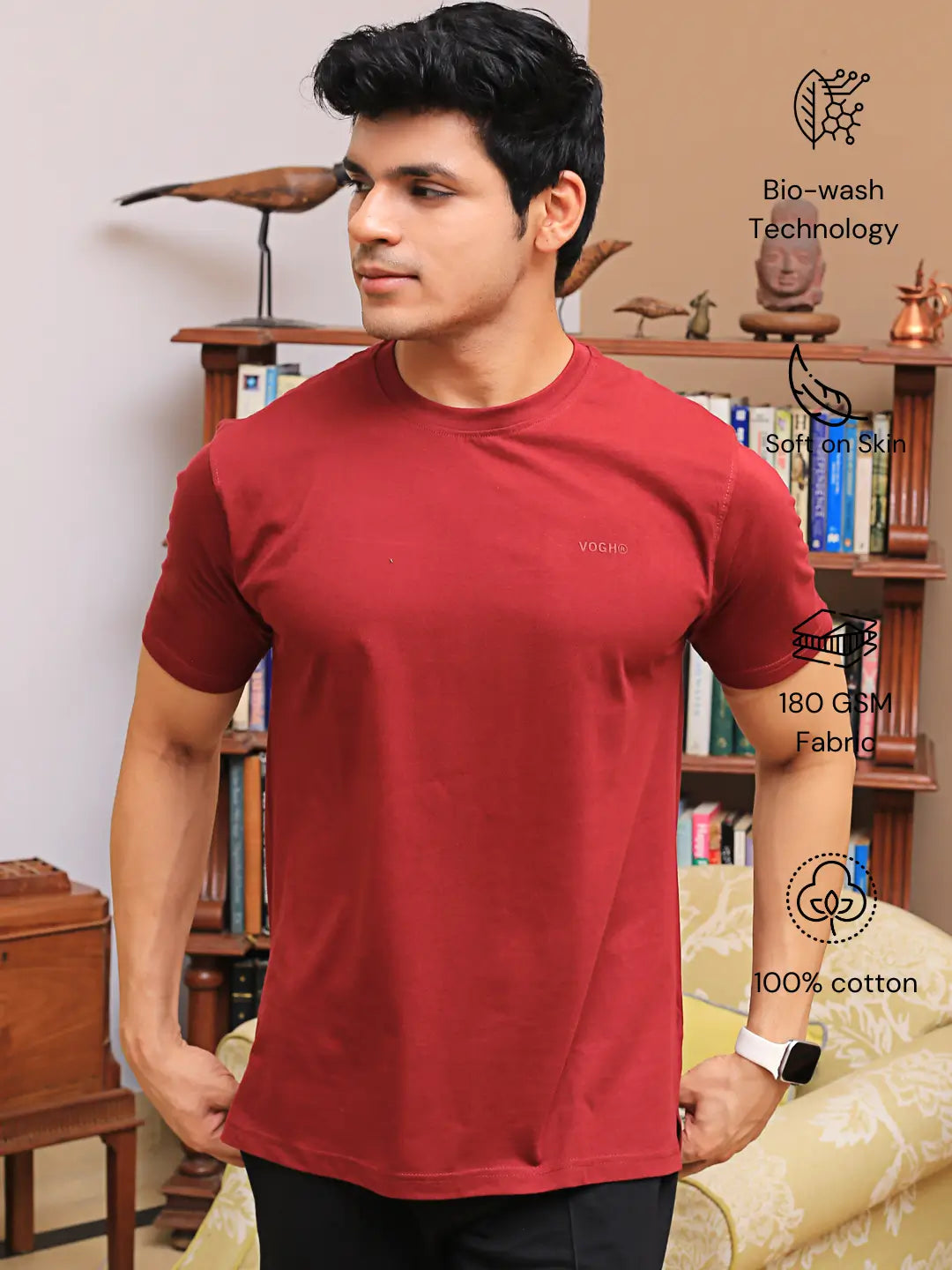 Man wearing a crew neck red cotton t-shirt, standing in a room
