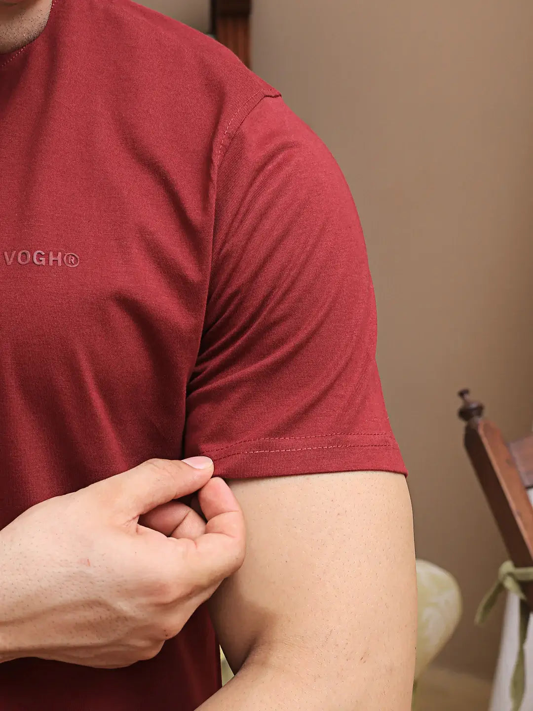 Person wearing a red round neck t-shirt