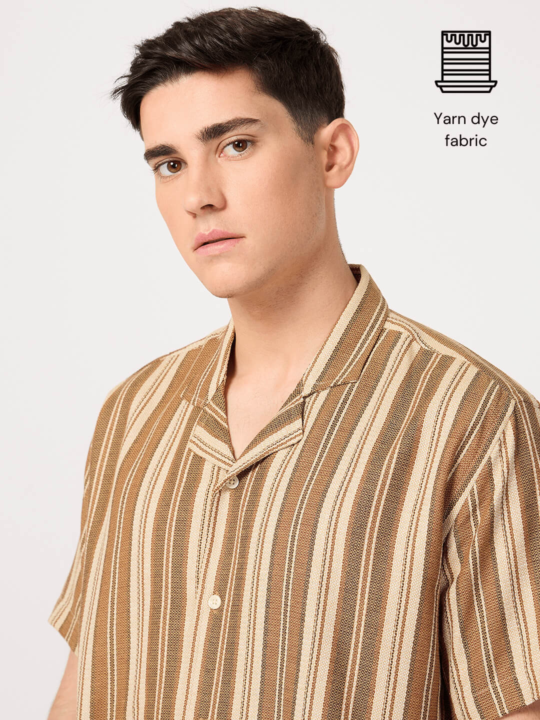 Man wearing a brown and beige striped resort shirt
