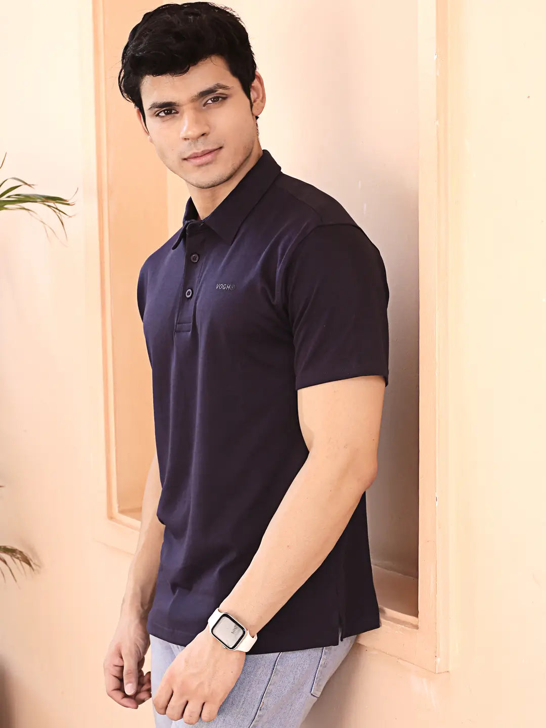 Man wearing a navy blue polo t shirt