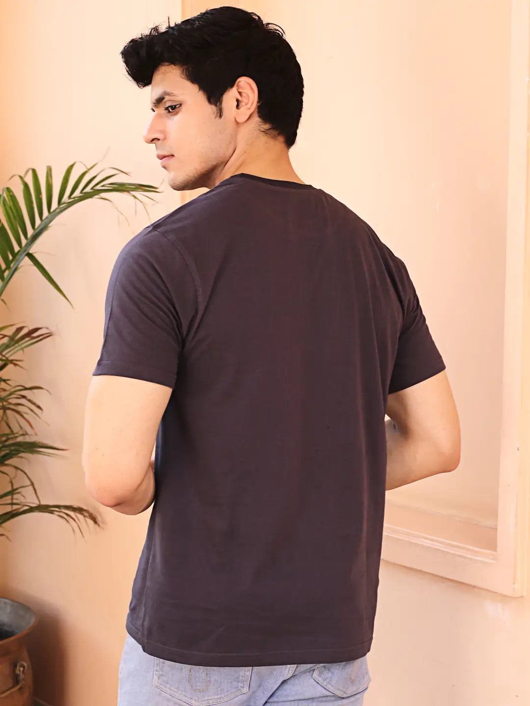 Man wearing a dark grey crew neck cotton t-shirt