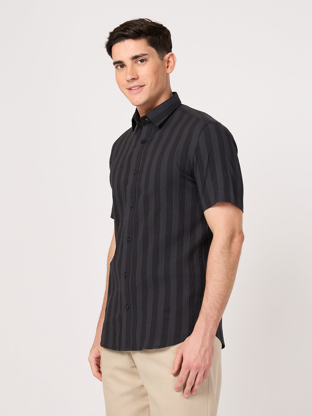 A man wearing a striped half sleeve shirt.