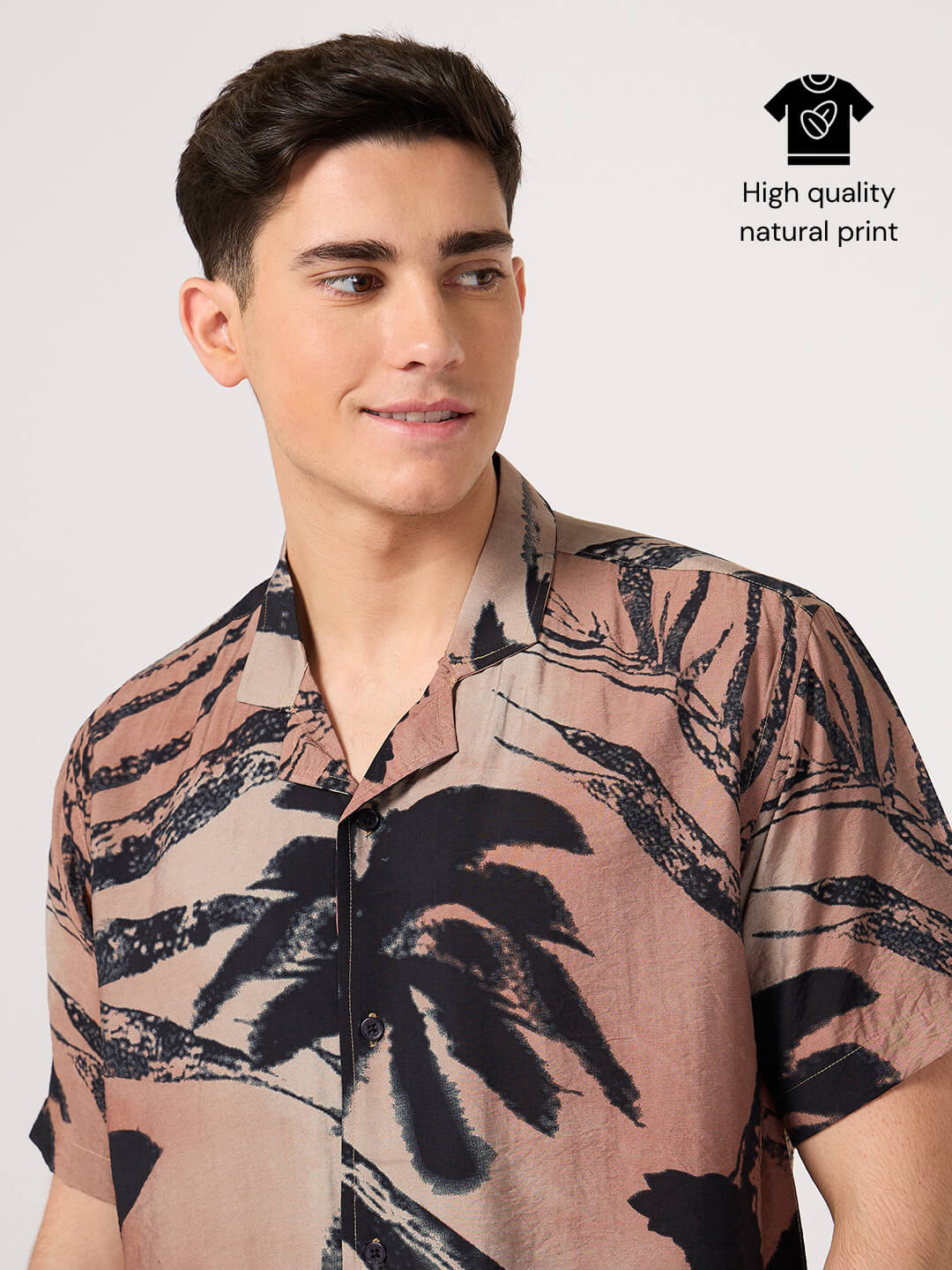 Man wearing a resort shirt with palm tree design
