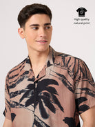 Man wearing a resort shirt with palm tree design