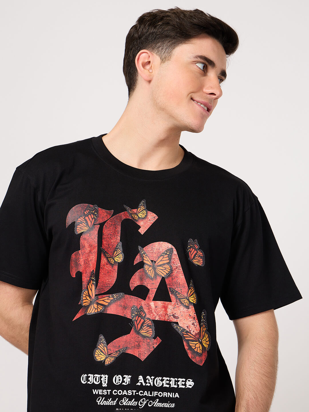man wearing a black LA printed t shirt