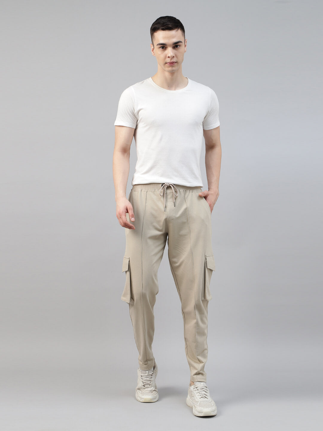 man wearing a white t shirt with beige cargo jogger pant