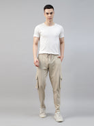man wearing a white t shirt with beige cargo jogger pant