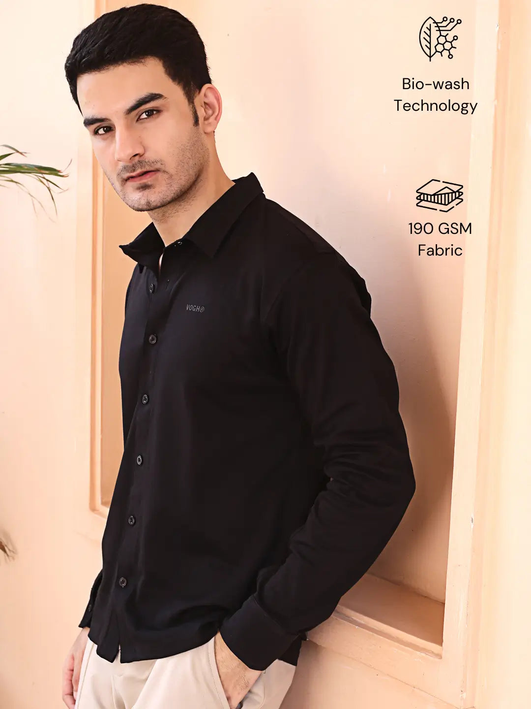 Man wearing a black cotton shirt with text about bio-wash technology