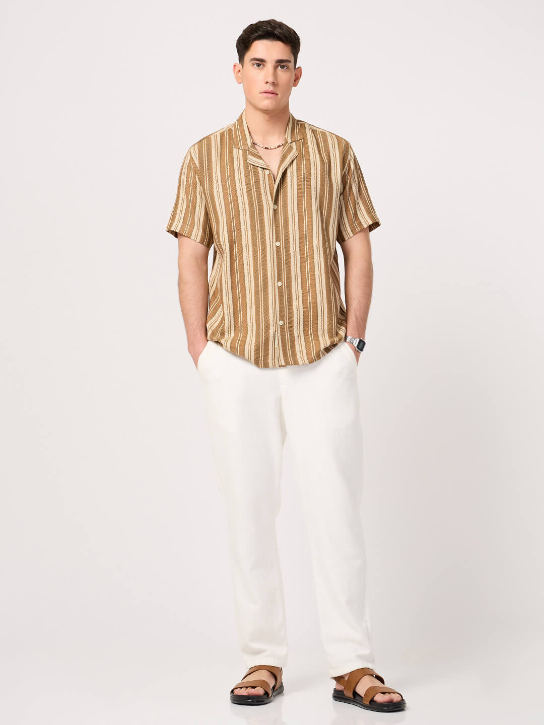 man wearing a brown and beige resort shirt with white trouser