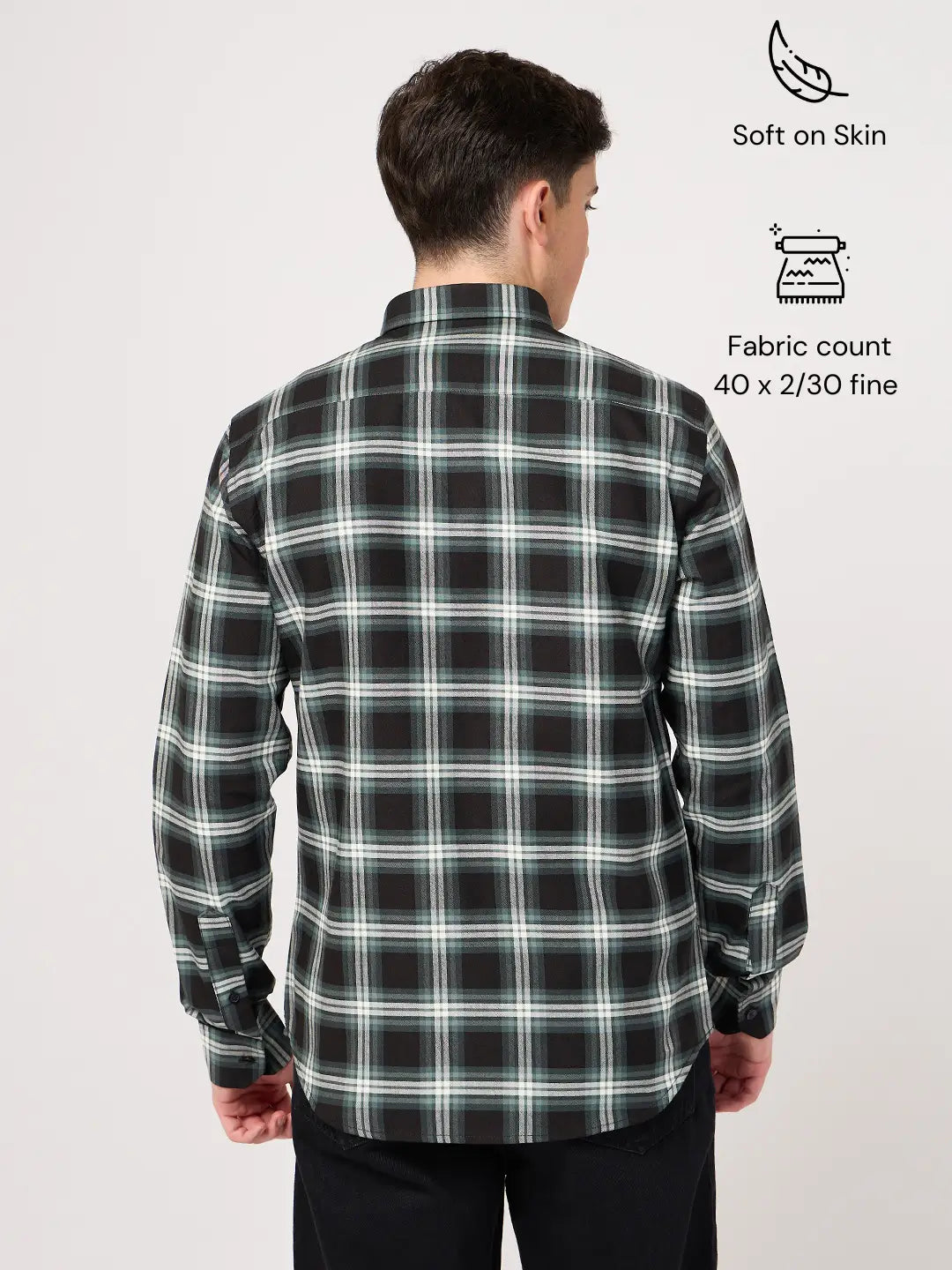 Man wearing a black and green plaid shirt