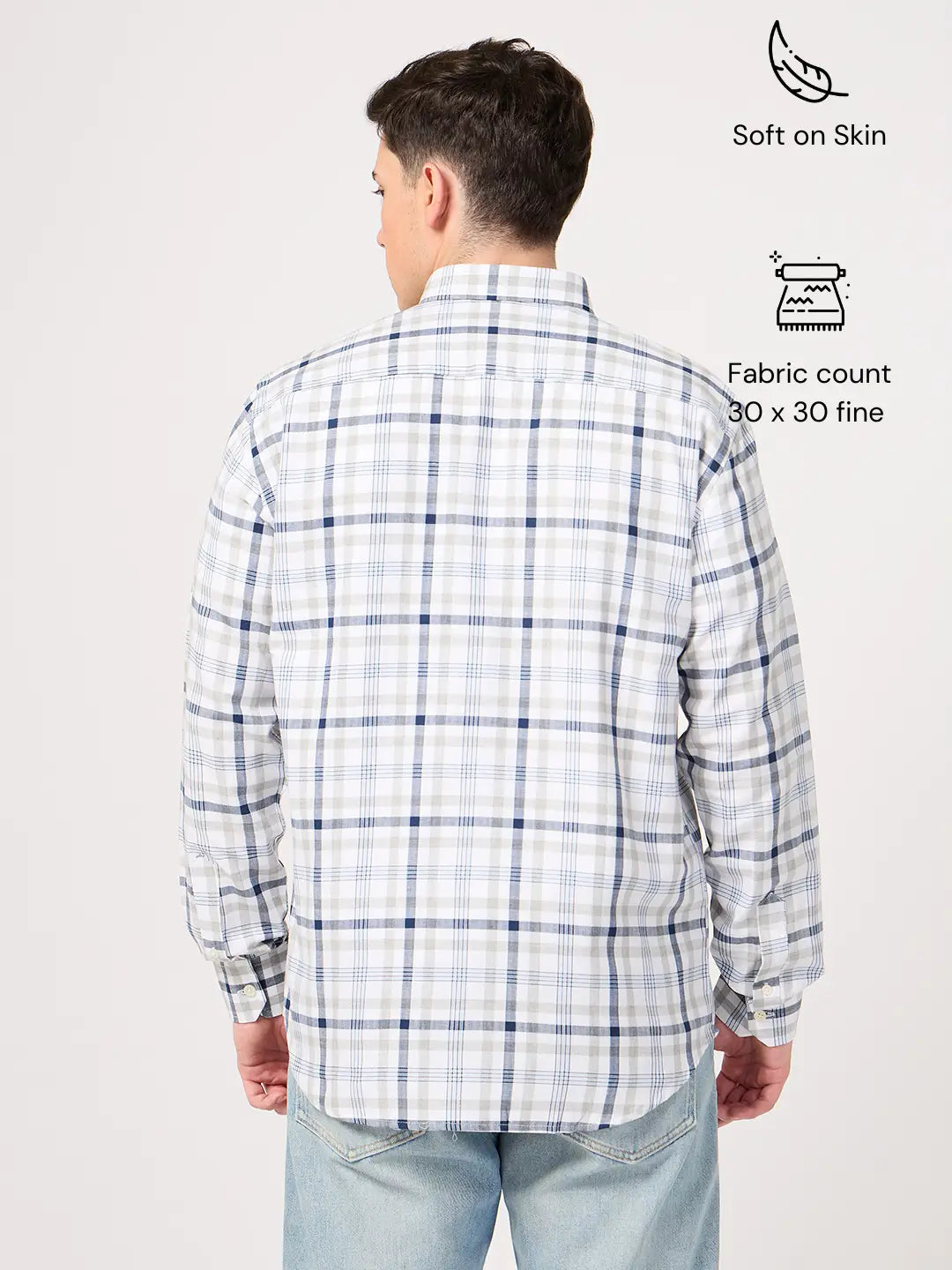 Man wearing a plaid shirt with text indicating shirt's features