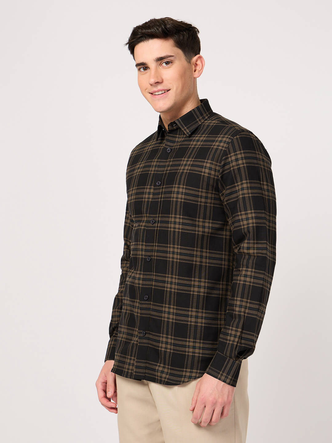 Man wearing a plaid shirt on a white background