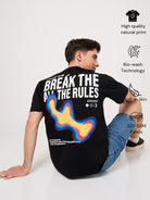 Person wearing a 'break all the rule' text printed black t-shirt