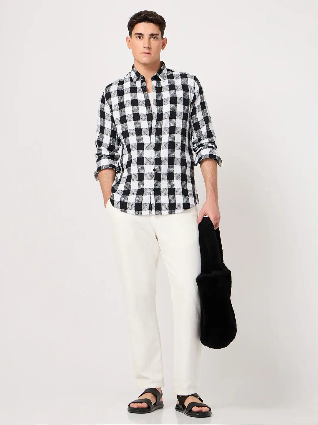 Man wearing a black and white checkered shirt and white pants