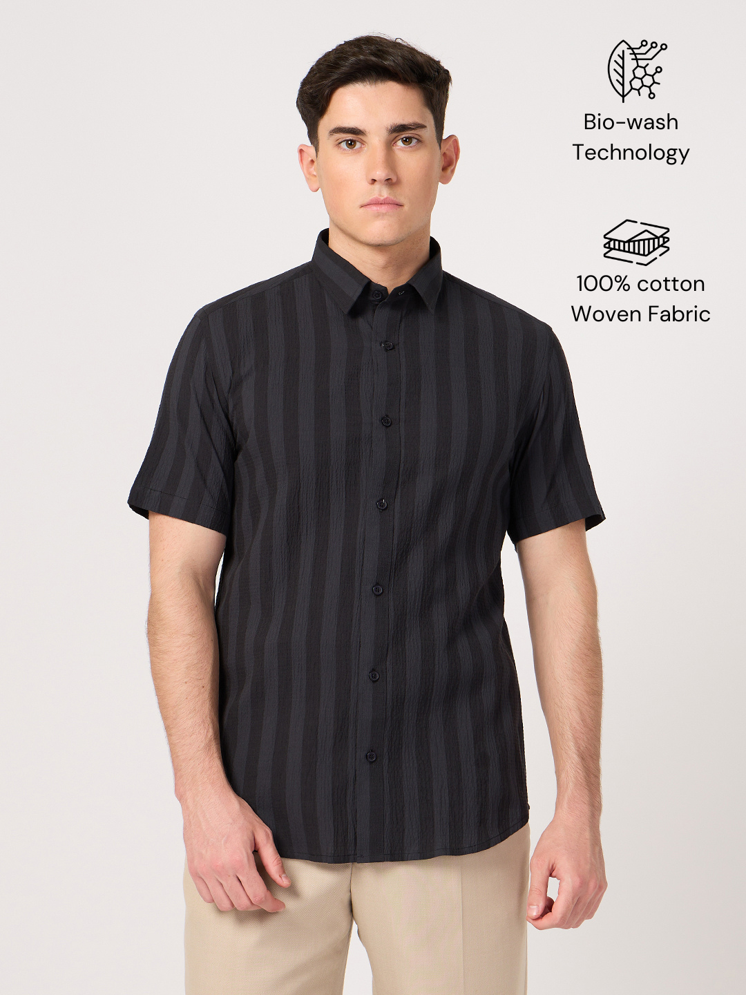 A man wearing a striped half sleeve shirt.