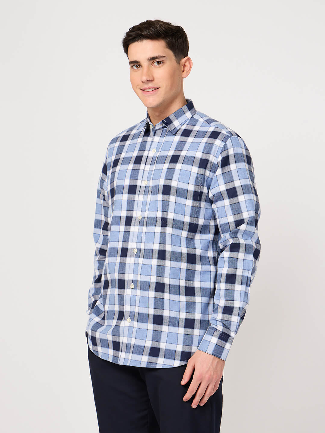 Man wearing a blue and white checkered shirt made with pure cotton