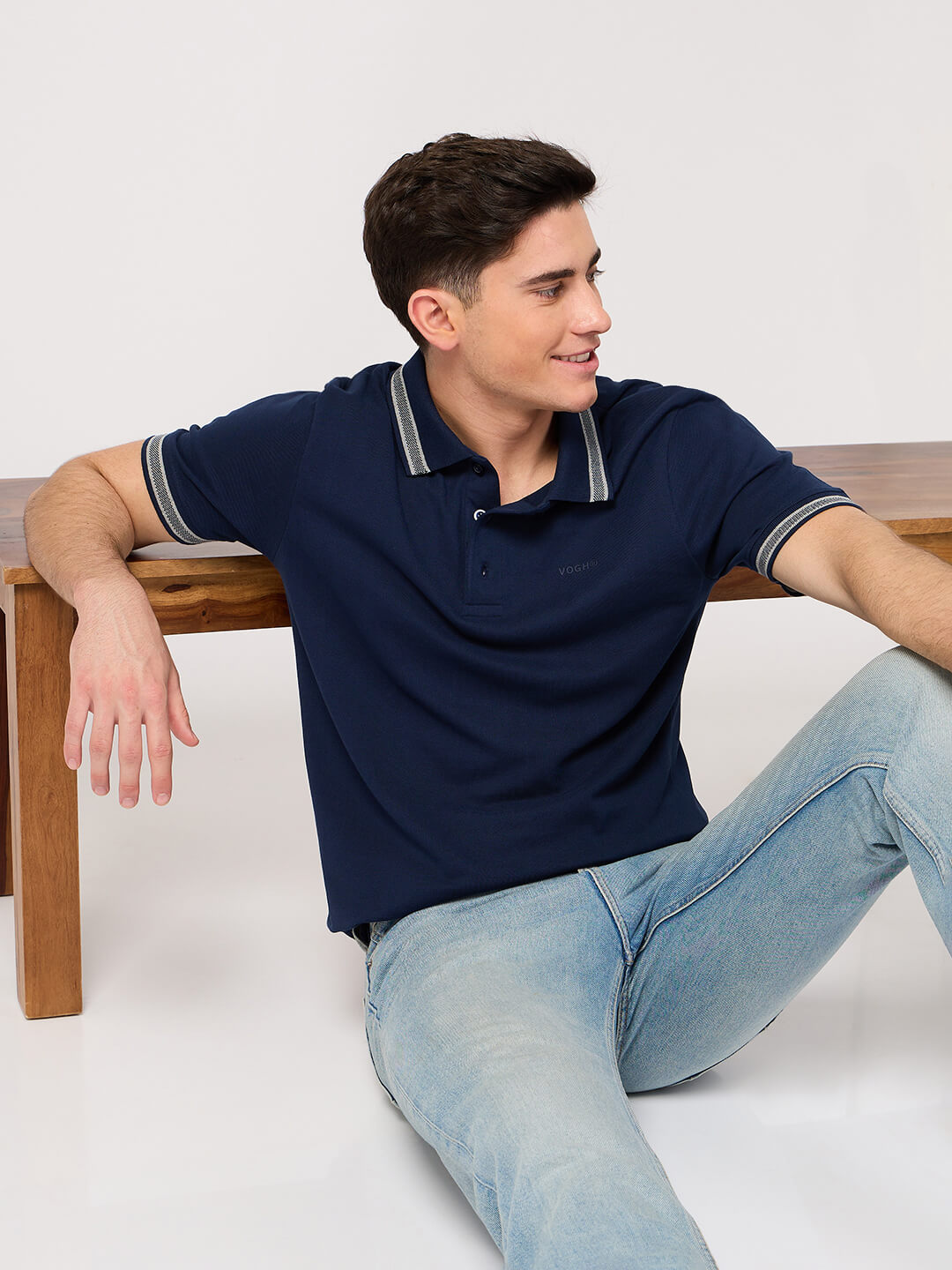 man wearing a polo t shirt and jeans