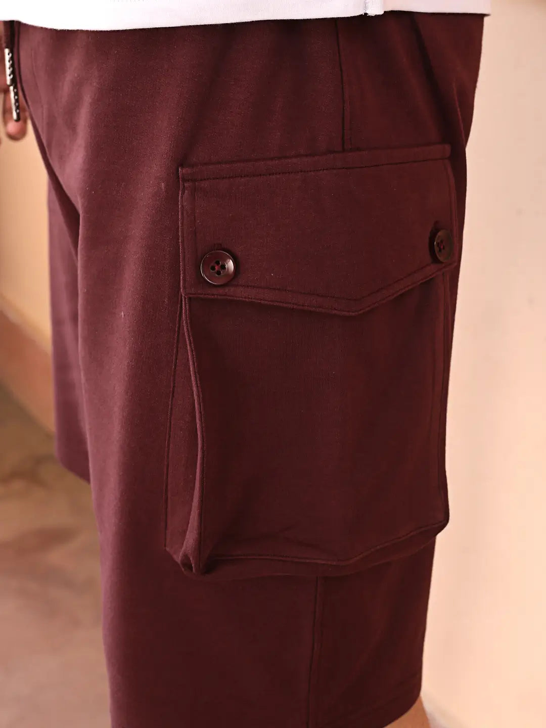 Close-up of maroon shorts with pockets