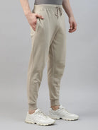 Person wearing beige jogger pants and white sneakers