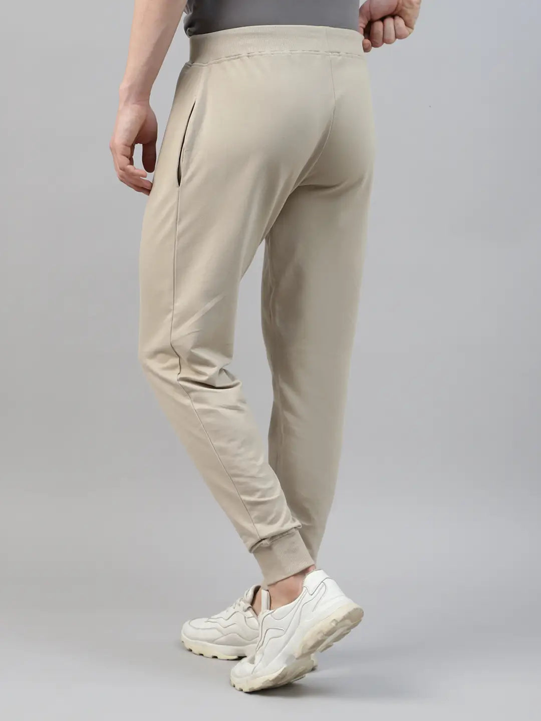 Beige rib jogger worn by a person on a gray background