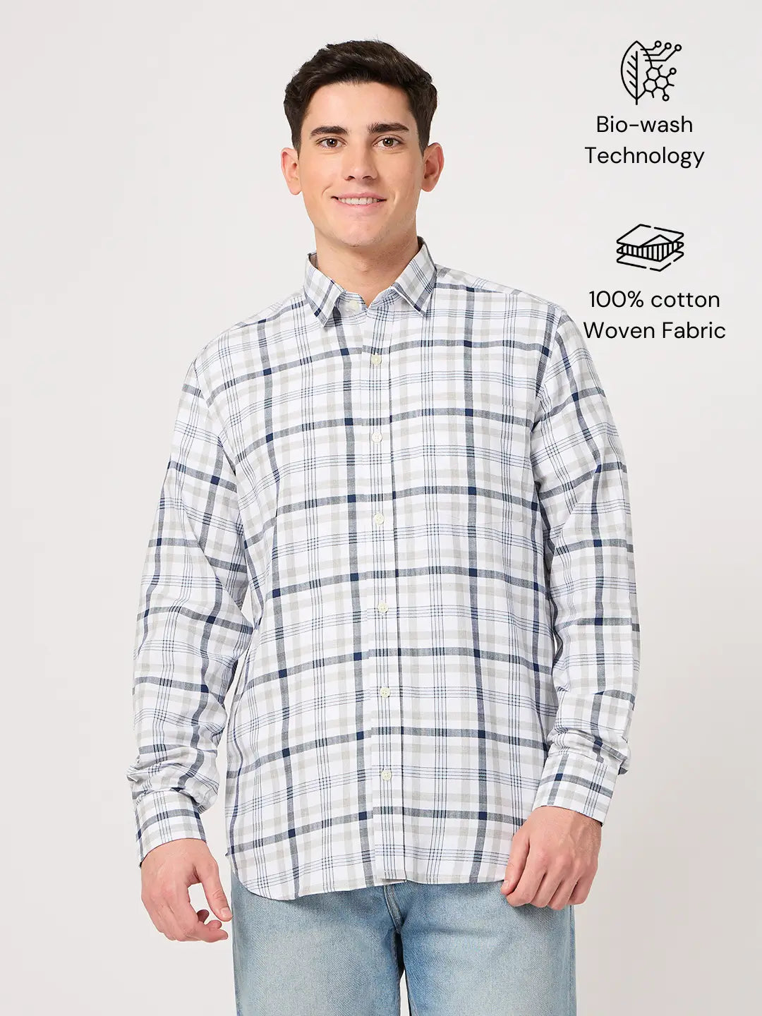 Man wearing a plaid shirt made with cotton fabric