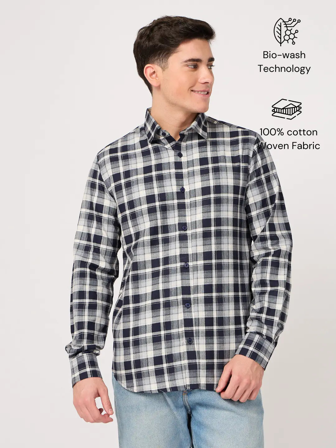 Man wearing a navy and white checkered shirt made with pure cotton fabric