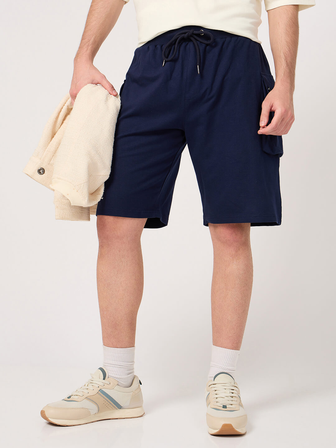 Person wearing navy cargo shorts