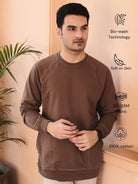 Man wearing a brown sweatshirt with pocket