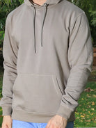 Person wearing a light gray hoodie