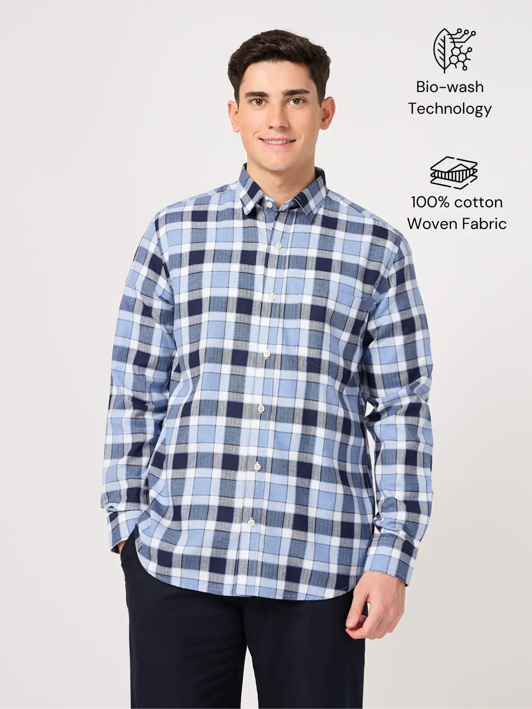 Man wearing a cotton blue check shirt with text indicating 'Bio-wash Technology' and '100% cotton Woven Fabric'.
