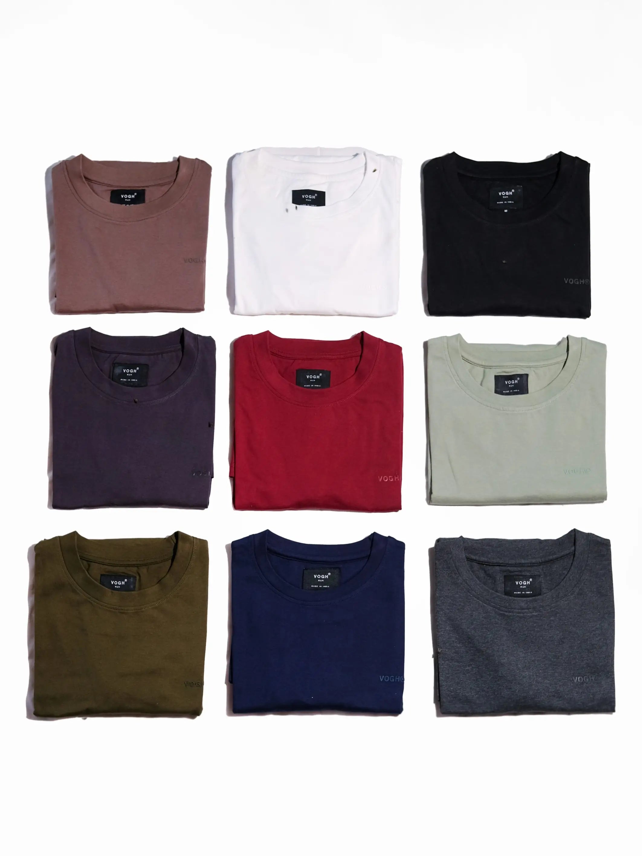 Collection of folded t shirts in various colors on a white background, combo offer