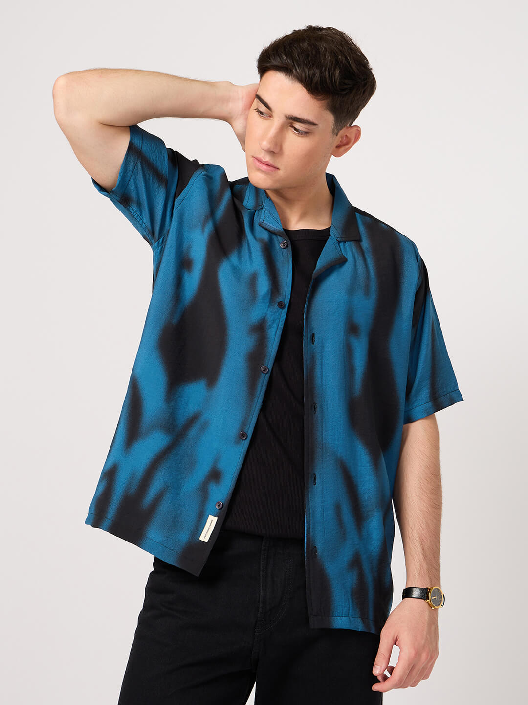 men wearing a blue and black resort shirt with short sleeves over a round neck tee