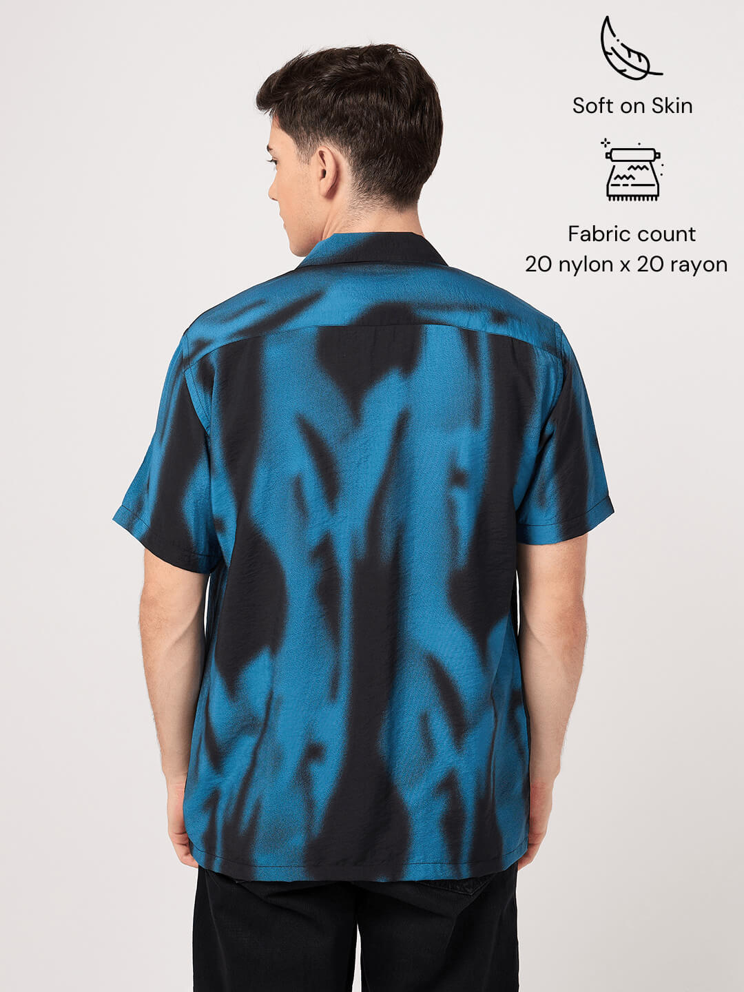 Person wearing a blue and black patterned resort shirt