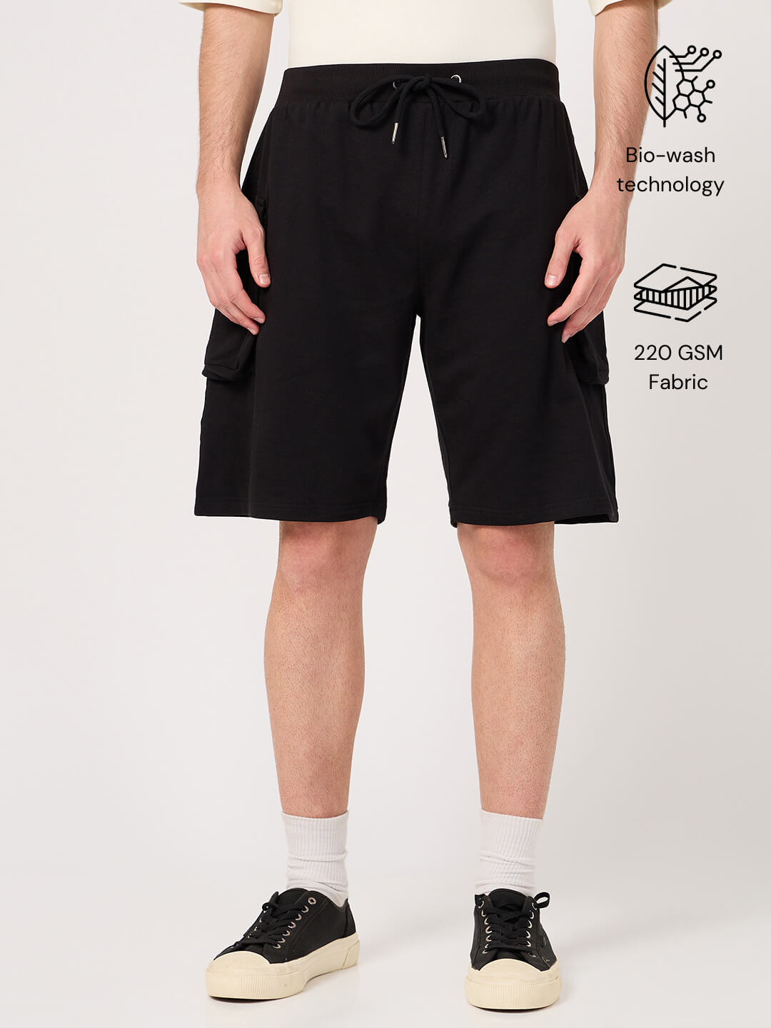 Person wearing black cotton cargo shorts