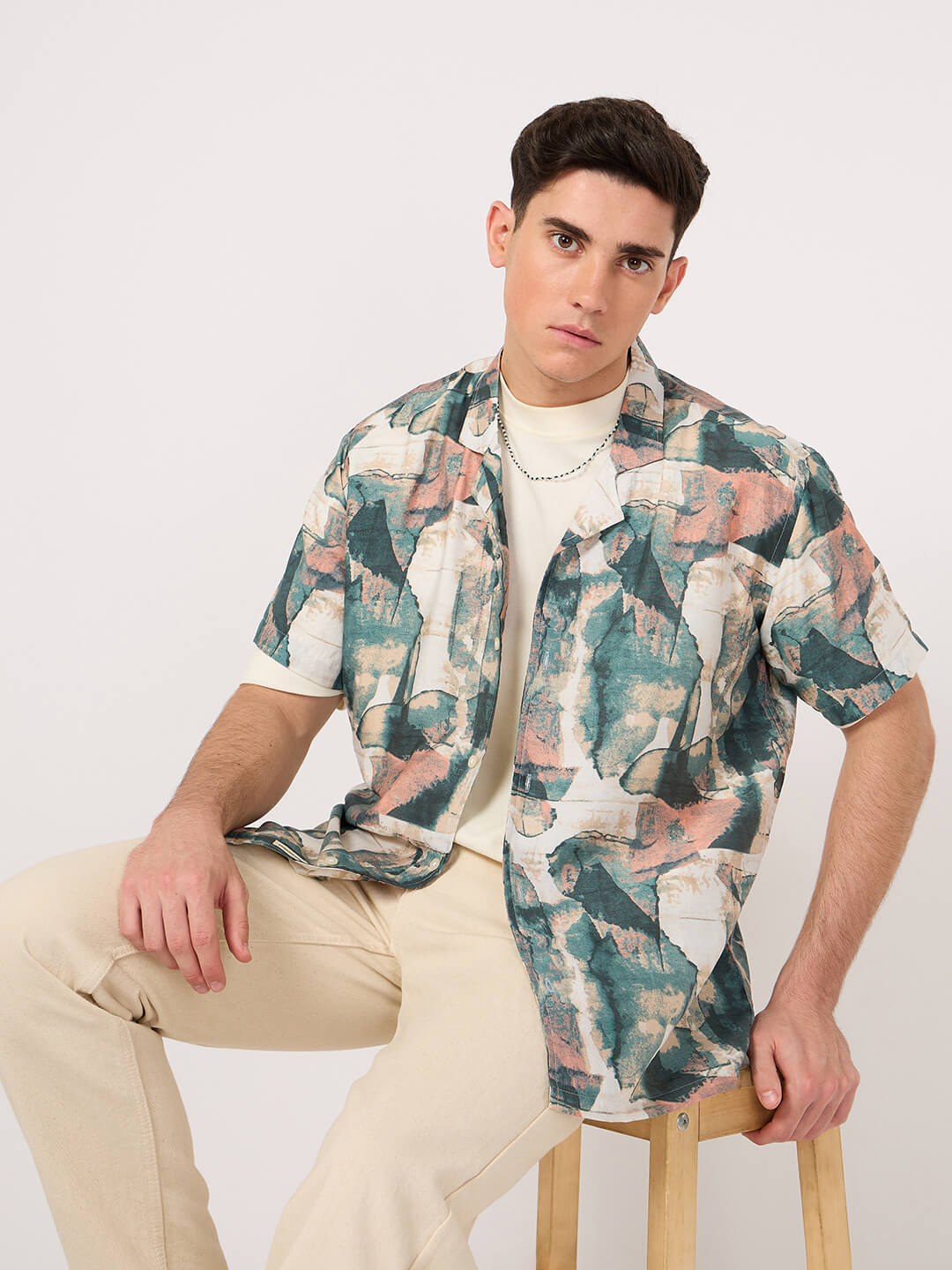 A man wearing a geometric patterned stylish Rayon Resort Shirt and beige trouser