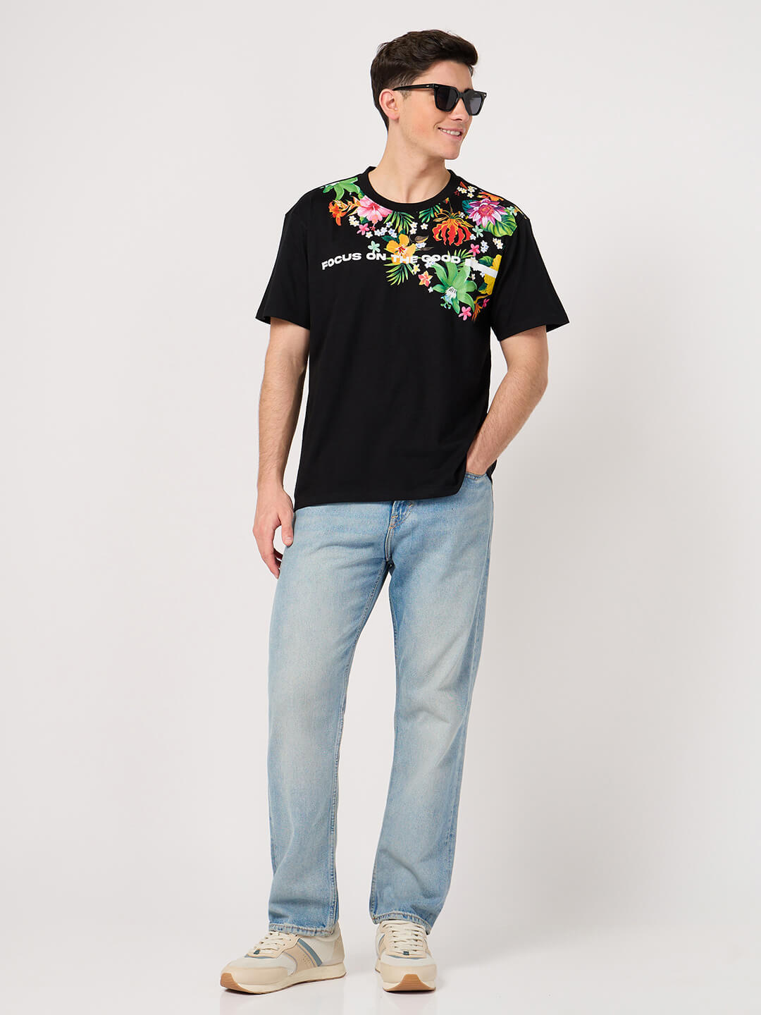 man wearing floral tshirt and jeans