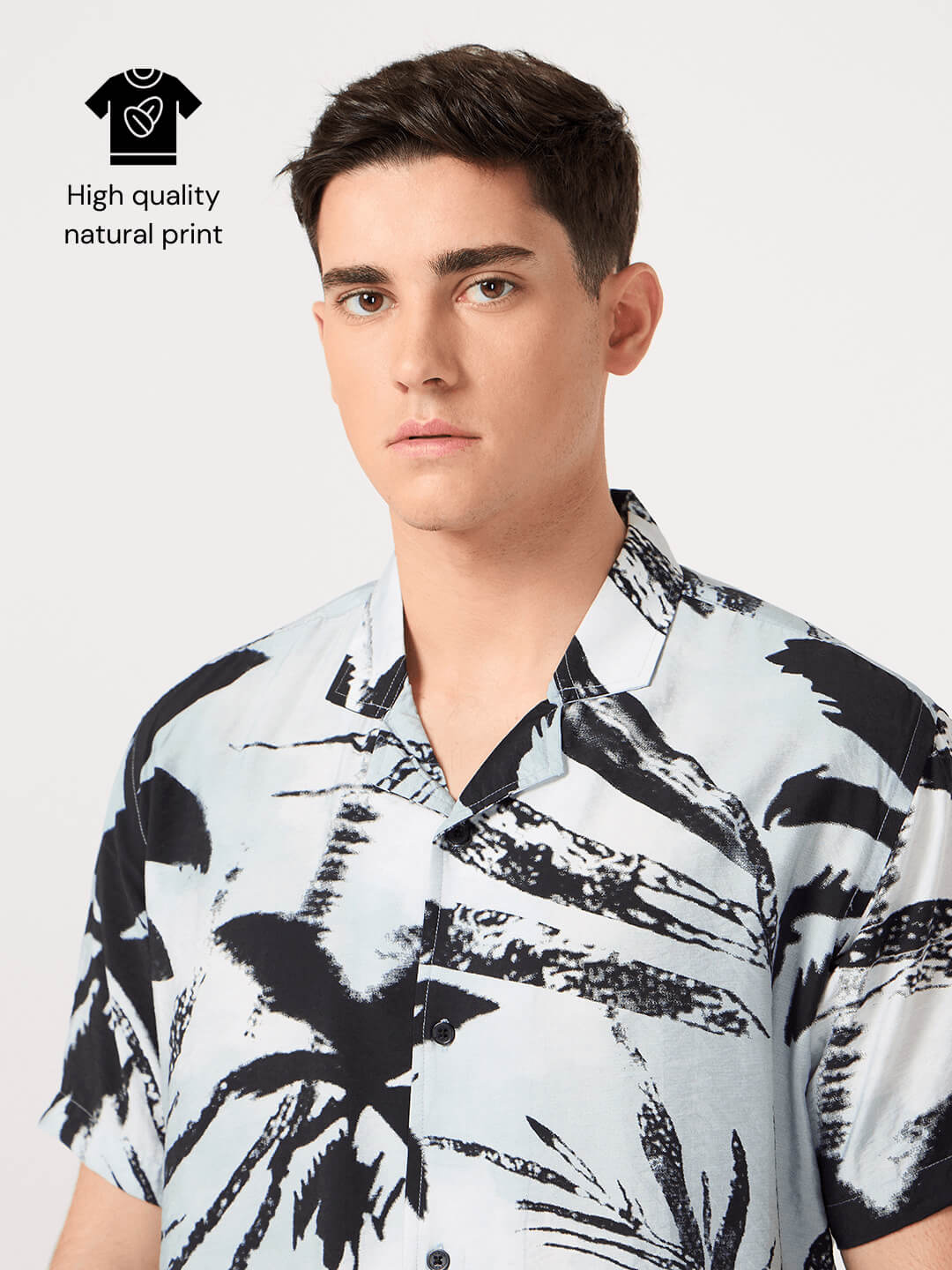 Man wearing a black and white patterned resort shirt