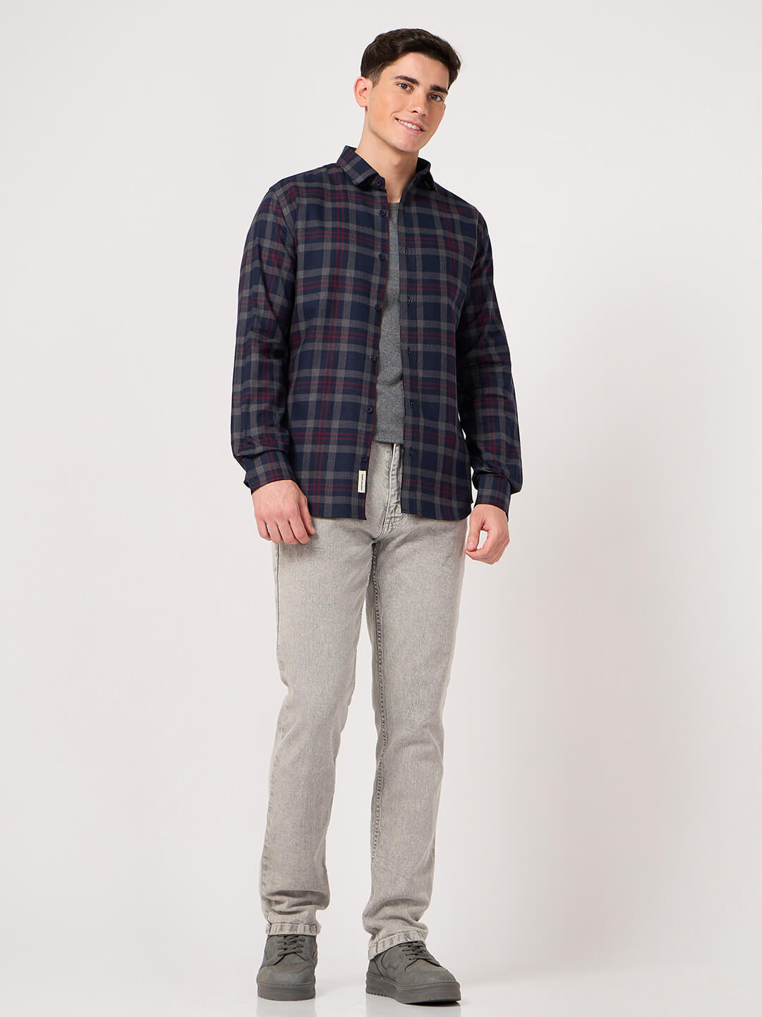 man in navy blue maroon check shirt and jeans