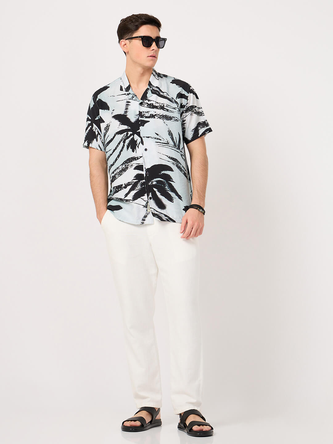 a man wearing resort shirt with a tropical print