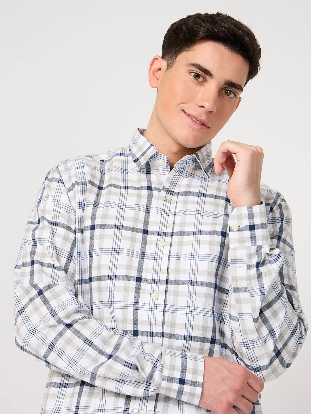 Man wearing a checkered shirt against a plain background