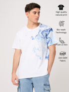 Person wearing a white t-shirt with blue abstract design on a light gray background