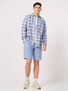 man in sky blue check shirt