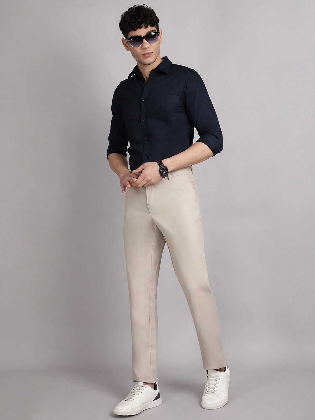 Man wearing a navy shirt and beige pants
