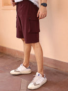 Person wearing maroon shorts and white sneakers