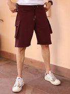 Person wearing maroon cargo shorts and white sneakers